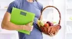Man-Holding-Scale-And-Basket-Of-Vegetables.webp Man-Holding-Scale-And-Basket-Of-Vegetables.webp