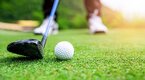 Golfer using a hybrid club on the fairway to hit the golf ball Golfer using a hybrid club on the fairway to hit the golf ball