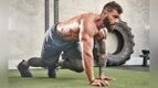 Muscular fit man with beard performing a bodyweight cardio exercise the bear crawl exercise Muscular fit man with beard performing a bodyweight cardio exercise the bear crawl exercise