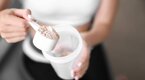 Athletic young woman preparing a protein shake