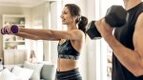 Fitness-Couple-Working-Out-At-Home-With-Dumbbells Fitness-Couple-Working-Out-At-Home-With-Dumbbells