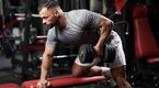 Fit man demonstrating a Unilateral Row With Rotation Fit man demonstrating a Unilateral Row With Rotation