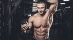 Shredded bodybuilder satisfied with the results of the supplements in his shake