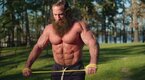 The Liver King working out using resistance bands