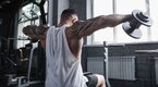 Fit young man performing Dumbbell Lateral Raise exercise Fit young man performing Dumbbell Lateral Raise exercise
