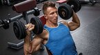 Muscular bodybuilder training with delt exercises to build his shoulder muscles Muscular bodybuilder training with delt exercises to build his shoulder muscles